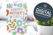 Load image into Gallery viewer, A photo of a card featured on a tabletop next to a white planter filled with a green plant. ​​The card features the words “Happy Mother’s Day” with illustrated flowers around the words. The words &quot;digital download&quot; are featured in a circle on top of the image.  