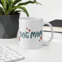 Load image into Gallery viewer, A white ceramic mug with the phrase Dog Mom in black letters with red heart shaped paws around the words. The mug makes a lovely gift for a dog owner. 