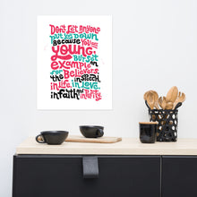 Load image into Gallery viewer, A white print hanging on a wall above a kitchen counter. The print has lettering in red, blue and black and reads &quot;Don&#39;t let anyone put you down because you are young, but set an example for the believers, in speech, in life, in love, in faith and in purity.&quot;