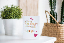Load image into Gallery viewer, A greeting card is featured on a desktop with a green plant in the background. The card features a couple illustrated hearts with the words “you’re the best mommy I could ever have. I love you.”