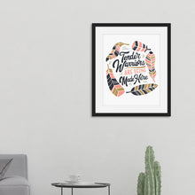 Load image into Gallery viewer, Artwork in a black frame featured in a room with hand drawn lettering reading &quot;Tender Warriors Are Being Made Here&quot; The words are in pink, navy and dark mustard yellow. 