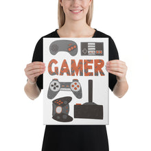 Load image into Gallery viewer, A woman holding a canvas in her hands with hand drawn lettering and illustrations featuring different game controllers and the word &quot;gamer.&quot; The illustrations and gamer word are in red, grey and black.  