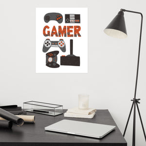 A canvas on a wall above a desk. The canvas is white and features hand drawn lettering and illustrations featuring different game controllers and the word "gamer." The illustrations and gamer word are in red, grey and black. 