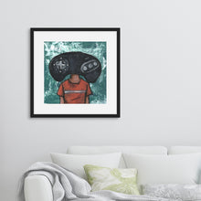 Load image into Gallery viewer, A black frame above a white sofa. The artwork in the frame is an illustration of the original Sega Genesis controller. 