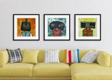 Load image into Gallery viewer, Three black frames featuring a vintage Nintendo controller, the second frame a Sega Genesis original controller, and the third frame is an Atari frame. The frames are featured on a wall in a living room above a yellow sofa. 