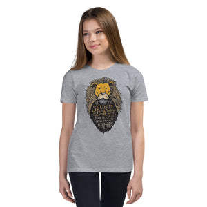 A girl wearing a light grey short sleeved T-Shirt. The T-Shirt features hand drawn illustration of the Chronicles of Narnia lion character Aslan. Inside the illustration there is the quote “At The Sound of Your Roar, Sorrows Will Be No More.”