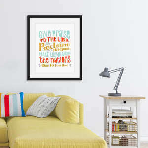 Lettering artwork is featured in a black frame above a sofa. The artwork has the Bible verse Psalm 105:1 "Give praise to the Lord, proclaim his name; make known among the nations what he has done."