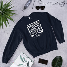 Load image into Gallery viewer, A navy sweatshirt laying on the ground with objects around it. The sweatshirt features hand drawn lettering in white with the words &quot;Our creativity is an outflow of His.&quot;