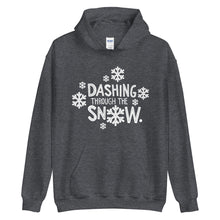 Load image into Gallery viewer, A dark grey hoodie on a white background. The hoodie features the song lyrics &quot;Dashing through the snow&quot; in white with white snowflake illustrations surrounding the words. 