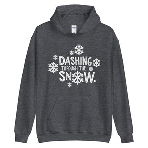 A dark grey hoodie on a white background. The hoodie features the song lyrics "Dashing through the snow" in white with white snowflake illustrations surrounding the words. 