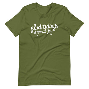 An olive green T-shirt on a white background. The navy shirt features words in white reading "glad tidings of great joy" in white. 