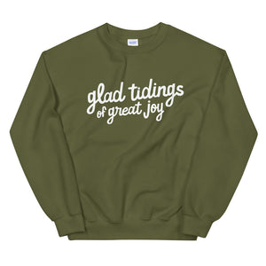 A green sweatshirt on a white background. The sweatshirt has the words "glad tidings of great joy" in white.