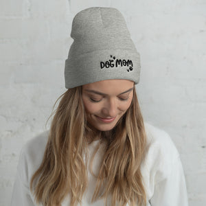 A light grey winter hat with the phrase Dog Mom on the hat’s cuff in black letters with black heart shaped paws around the phrase. The beanie hat makes an excellent gift for dog lovers. 