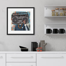 Load image into Gallery viewer, A black frame on a wall above a kitchen counter. In the frame is an illustrated image of a boombox with a person wearing a gold chain and blue jacket.
