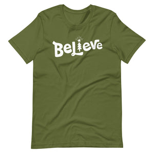 An olive green T-shirt on a white background. The red shirt features the hand lettered word "Believe" in white with the "I" featured as an illustrated Christmas tree. 