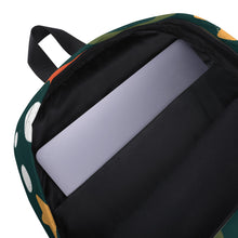 Load image into Gallery viewer, The inside of a backpack showing the laptop pocket. The backpack is hunter green with a fun pattern of yellow stars, green swirls, blue &quot;splats&quot; and other fun whimsical shapes. The backpack straps are black. 