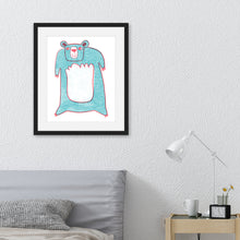 Load image into Gallery viewer, An illustration of a blue bear in a black frame. The frame is hanging on the wall above a bed with a grey headboard. 