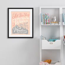 Load image into Gallery viewer, A pink print hanging on a pale grey wall, next to white bookshelves. The print reads &#39;Let her sleep for when she wakes she will move mountains&#39; in a pink, white, and light grey lettering design, with a grey mountain illustration at the bottom.