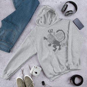A light grey hoodie laying on the ground with objects around it. The hoodie features hand drawn illustration of the Chronicles of Narnia lion character Aslan. Inside the illustration there is the quote "Course He Isn't Safe, But He's Good. He's the King."