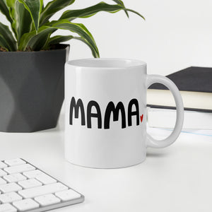 A white ceramic mug featuring the word Mama in black with a red heart at the end of the word. This is a perfect mug for moms to enjoy a warm drink. 