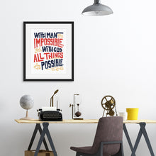 Load image into Gallery viewer, A black frame above a desk with artwork printed on white paper. The artwork features hand drawn lettering with the Matthew 19:26 Bible verse reading &quot;With man this is impossible but with God all things are possible.&quot;  The lettering is in navy, red and mustard yellow. 