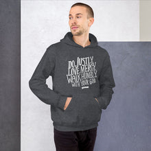Load image into Gallery viewer, A man wearing dark grey hoodie with the Bible verse words Do justly, love mercy, walk humbly, with your God, Micah 6:8 in white lettering. 