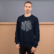 Load image into Gallery viewer, A man wearing a navy sweatshirt with white lettering featuring Do justly, love mercy, walk humbly, with your God, Micah 6:8.