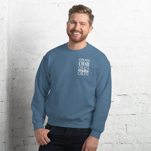 Load image into Gallery viewer, A man wearing an indigo blue sweatshirt with the word &quot;create, create, create, create, create&quot; in white in a small rectangle on the upper left side.