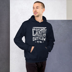 A man wearing a navy hoodie featuring hand drawn lettering in white with the words "Our creativity is an outflow of His."