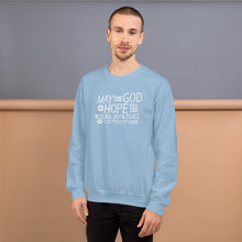Load image into Gallery viewer, A man wearing a light blue sweatshirt featuring hand drawn lettering in white with the words &quot;May the God of hope fill you with all joy and peace as you trust him.&quot;