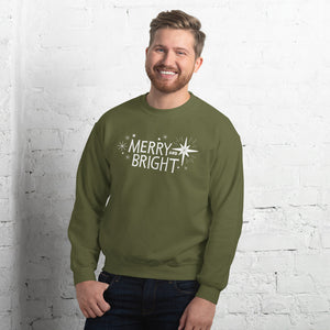A man wearing a hunter green sweatshirt featuring hand drawn lettering and star illustrations in white. The words Merry and Bright are in the middle with white stars surrounding the words. 