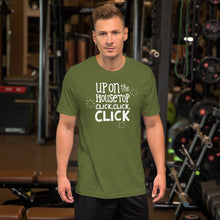 Load image into Gallery viewer, A man wearing an olive green short sleeved t-shirt. The tee features lettering of the words &quot;Up on the housetop, click, click, click.&quot; The words are in white with three stars in white surrounding the words. 