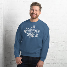 Load image into Gallery viewer, A man wearing a indigo blue sweatshirt featuring hand drawn lettering with the words &quot;Dashing through the snow&quot; in white. There are snowflakes around the words. 