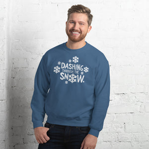 A man wearing a indigo blue sweatshirt featuring hand drawn lettering with the words "Dashing through the snow" in white. There are snowflakes around the words. 
