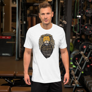 A man wearing a white short sleeved T-Shirt. The T-Shirt features hand drawn illustration of the Chronicles of Narnia lion character Aslan. Inside the illustration there is the quote “At The Sound of Your Roar, Sorrows Will Be No More.”