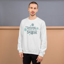 Load image into Gallery viewer, A man wearing a white sweatshirt featuring hand drawn lettering with the words &quot;Dashing through the snow&quot; in light and dark blue. There are snowflakes around the words. 
