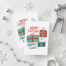 Load image into Gallery viewer, Two Christmas cards laying on a white background with white and silver Christmas decorations on the table. The card has a white background with the words &quot;Merry Everything and Happy Always.&quot; There are three illustrated Christmas gifts in light red, green and blue with patterns on them.