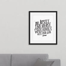 Load image into Gallery viewer, Framed artwork in a black frame on a wall above a sofa featuring a white paper print with black lettering featuring the Bible verse “Do justly, love mercy, walk humbly, with your God, Micah 6:8.”