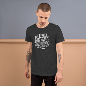 A dark grey tee with white lettering and the Bible verse Do justly, love mercy, walk humbly, with your God, Micah 6:8. 