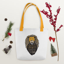 Load image into Gallery viewer, A white tote bag with mustard yellow handles laying on a white tabletop with pinecones and a red berry branch around it. The tote bag has mustard yellow handles and an illustration of the Aslan character. Inside the illustration there is the quote “At The Sound of Your Roar, Sorrows Will Be No More.” 
