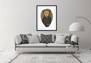 A black frame with artwork hanging above a light grey sofa in a living room. The artwork features an illustrated Aslan (the lion from Chronicles of Narnia). Inside the lion the Narnia quote is featured reading “At The Sound of Your Roar, Sorrows Will Be No More.”