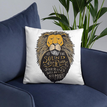 Load image into Gallery viewer, A white square pillow sitting on a blue sofa chair with a plant in the background. The pillow artwork features hand drawn illustration of the Chronicles of Narnia lion character Aslan. Inside the illustration there is the quote “At The Sound of Your Roar, Sorrows Will Be No More.”