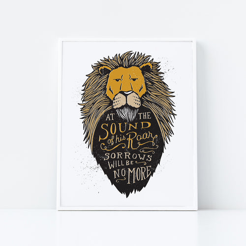 Artwork in a white frame with the with a white matte. The frame is leaning on a white counter. The artwork features an illustrated Aslan (the lion from Chronicles of Narnia). Inside the lion the Narnia quote is featured reading “At The Sound of Your Roar, Sorrows Will Be No More.”