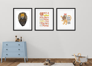 Three black frames with quote illustrations featured on a wall in a nursery. Frame one features a lion's head illustration of Aslan with the quote "At The Sound of Your Roar, Sorrows Will Be No More." The second frame featuring letter artwork reading "Once a king or queen of Narnia, always a king or queen of Narnia." The third frame has an illustration of a lion saying "Course He Isn't Safe, But He's Good. He's the King."