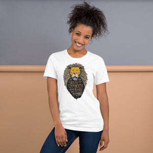 A woman wearing a white short sleeved T-Shirt. The T-Shirt features hand drawn illustration of the Chronicles of Narnia lion character Aslan. Inside the illustration there is the quote “At The Sound of Your Roar, Sorrows Will Be No More.”