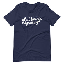 Load image into Gallery viewer, A navy blue T-shirt on a white background. The navy shirt features words in white reading &quot;glad tidings of great joy&quot; in white. 