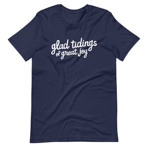 A navy blue T-shirt on a white background. The navy shirt features words in white reading "glad tidings of great joy" in white. 