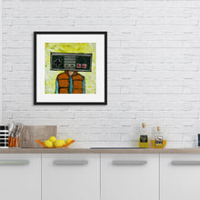 Load image into Gallery viewer, An illustration of an original Nintendo as a head of a person inside a black frame. The frame is above a kitchen counter.