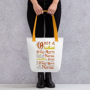 A woman holding a white tote bag with mustard yellow colored handles. The artwork features hand drawn lettering of the Narnia quote "Once a king or queen of Narnia, always a king or queen of Narnia." 