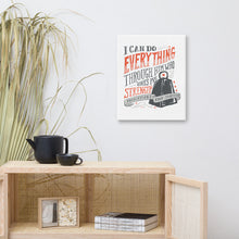 Load image into Gallery viewer, A canvas shown on a wall above a shelf. The canvas is white and features hand drawn lettering in red and black with the phrase &quot;I can do everything through him who gives me strength&quot; and Philippians 4:13 at the bottom of the verse. 